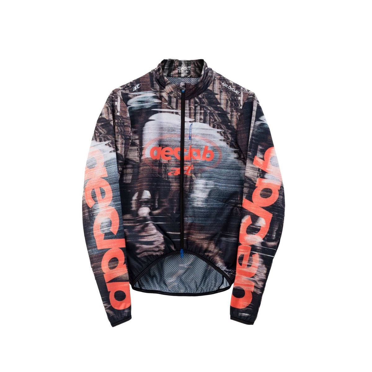 Women's WINTER thermal Jersey in black and gray with abstract pattern, featuring orange branding on sleeves and chest with full zipper.